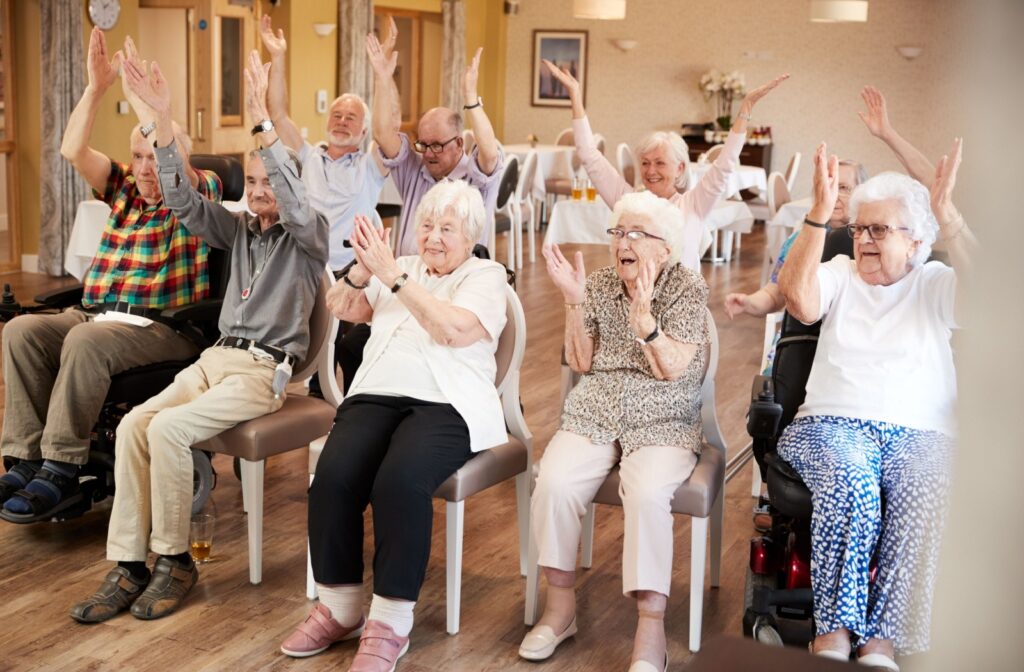 A group of seniors participate in a group light movement exercise together.